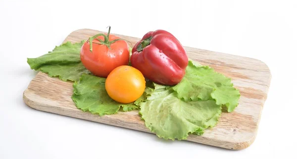 vegetables lie on a wooden board, top view