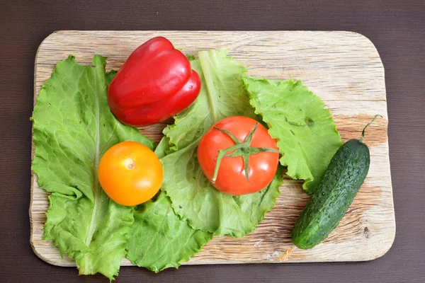 vegetables lie on a wooden board, top view