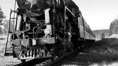 Republic of Karelia, Russia: Retro train on steam locomotive traction black and white video old movie.