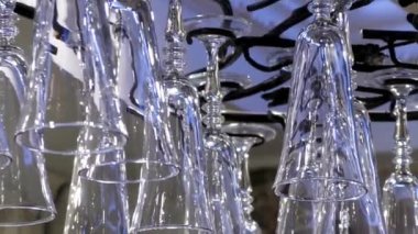 Clean glasses are hanging at the bar.