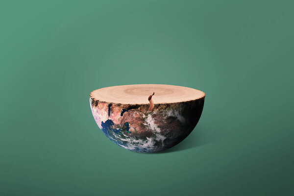 Planet earth and felled tree with rings, concept. Preserving the environment and cutting down trees. Creative wood stump and earth. Ecosystem and ecology 