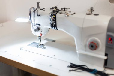 Çalışma odasında beyaz dikiş makinesi var. Giysi yaratma konusunda yaratıcı çalışma