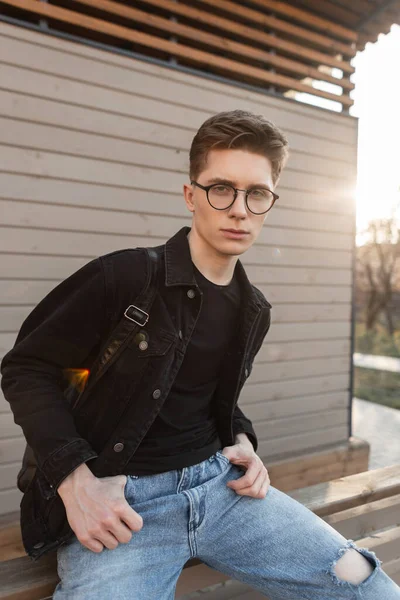 Confident Young Man Hipster Fashionable Denim Clothing Stylish Glasses Sits — Stock Photo, Image