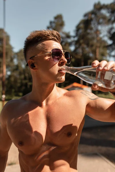 Jovem Bonito Com Corpo Muscular Faz Treino Bebe Água Livre — Fotografia de Stock