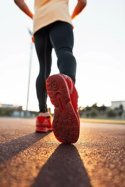 ファッショナブルな赤いスニーカーのアスレチックマンは日没時に走ります 靴を閉じる実行している男性 — ストック写真