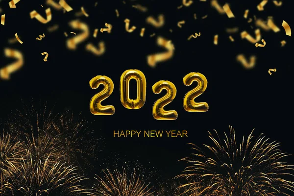 Golden Balloons 2022 New Year\'s Eve on a black background with gold fireworks and confetti. Luxury golden color. Happy New Year, concept idea. Creative design