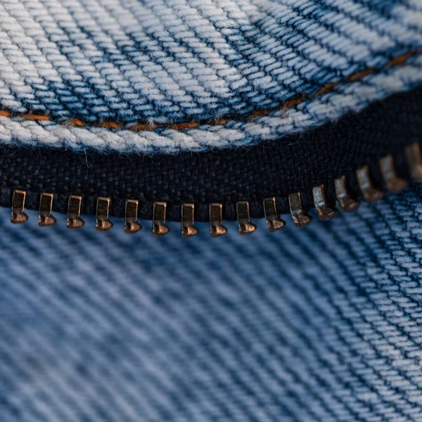 Blue fashion Jeans and metal zipper, macro. Denim texture