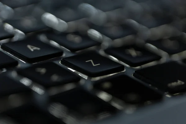 Laptop keyboard with letters, close-up