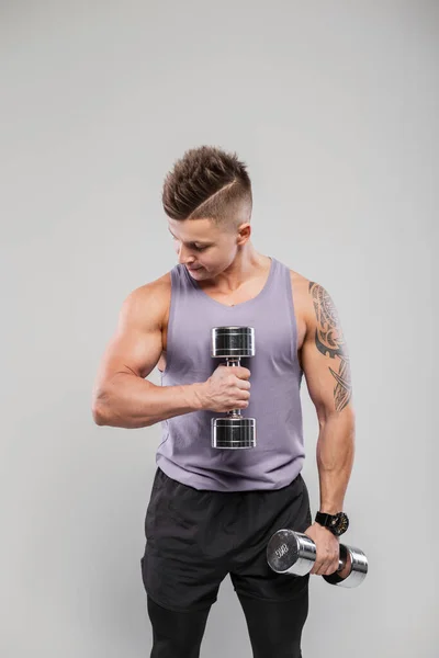 Handsome Strong Sporty Man Hairstyle Sportswear Workout Dumbbells Gray Background — 스톡 사진