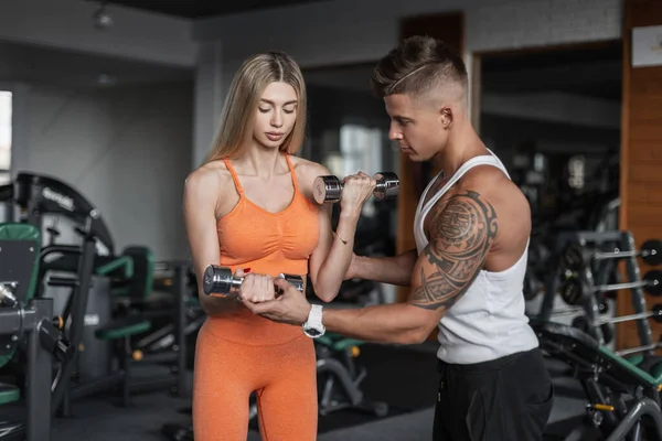 Athletic Young Beautiful Couple Sportswear Working Out Metal Dumbbells Gym — Stockfoto