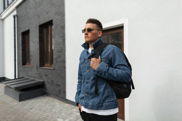 Handsome Hipster Man Trendy Sunglasses Fashion Denim Clothes Backpack Stands — Foto de Stock