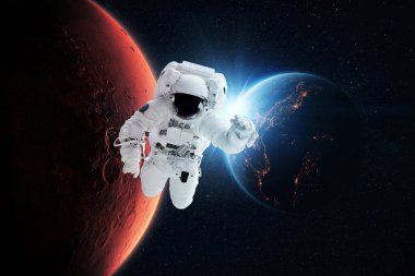 Beautiful astronaut flies in zero gravity on a background of the blue planet Earth with the rays of the sun and the red planet Mars. Space mission and exploration of new space concept. Spaceman fly