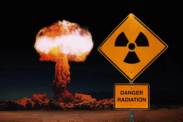 Yellow sign danger radiation against the background of a nuclear explosion. World nuclear war. Explosion, concept. Global catastrophe. Nuclear mushroom