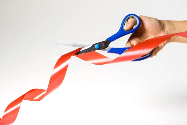 Scissors Cutting Red Ribbon on white background isolated — Stock Photo, Image