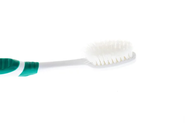 Green worn toothbrush on isolated white background — Stock Photo, Image