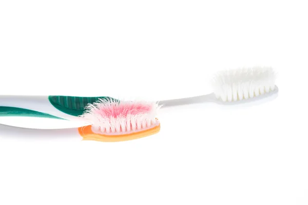 Two Color worn toothbrush on isolated white background Royalty Free Stock Photos