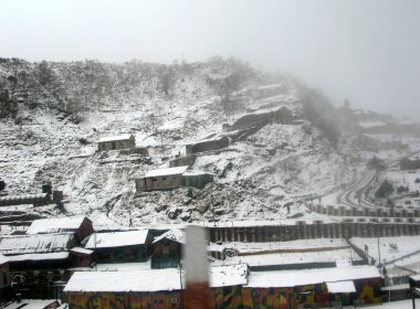 A view of snow-covered houses after the fresh snowfall looks mesmerizing at Thegu situated at 13,000 ft altitude near the Indo-China border in East Sikkim, India. 