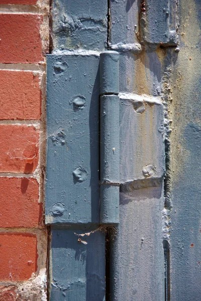Weathered Blue Iron Door Hinge Old Red Brick Wall Building — Stockfoto