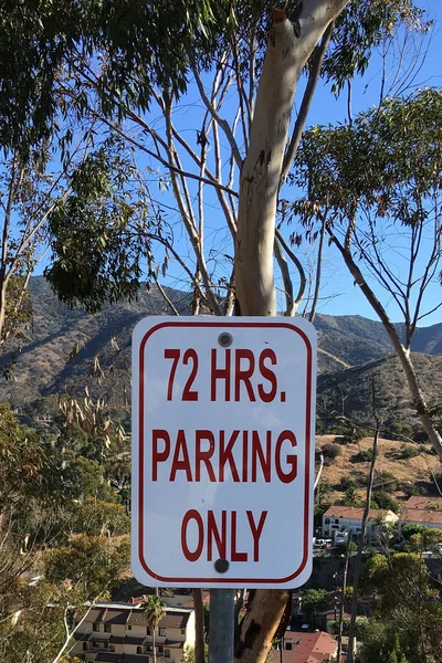 72 HOURS PARKING ONLY sign on a rural hill road
