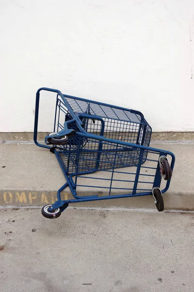 Blue shopping cart abandoned in rooftop parking lot