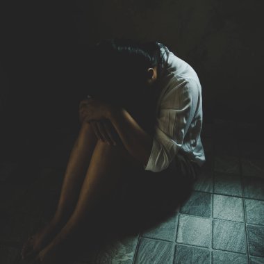 Young depressed woman, domestic and rape violence,beaten and raped sitting in the corner