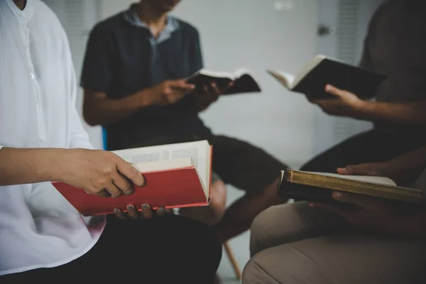 Group of people are reading the bible. soft focus, praying and praise together at home. devotional or prayer meeting concept.