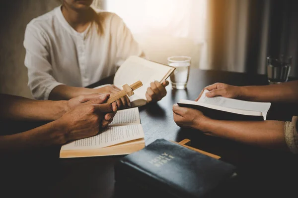 Group of people are reading the bible. soft focus, praying and praise together at home. devotional or prayer meeting concept.