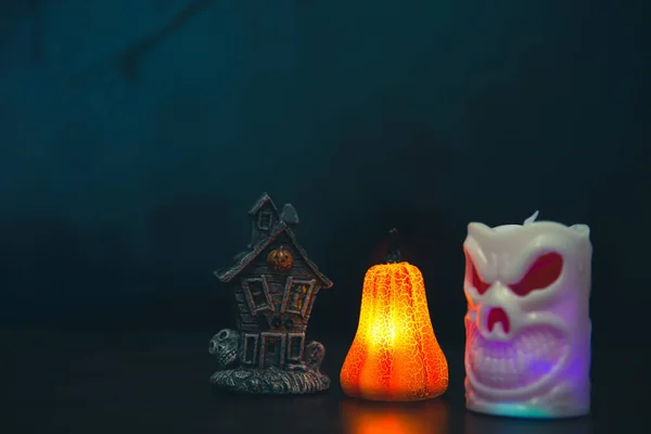 Halloween pumpkin head jack lantern with burning candles. Pumpkins in graveyard in the spooky night - halloween backdrop