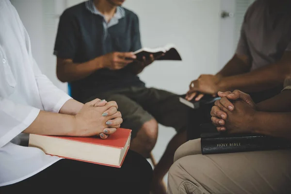 Group of people praying worship believe. soft focus, praying and praise together at home. devotional or prayer meeting concept.