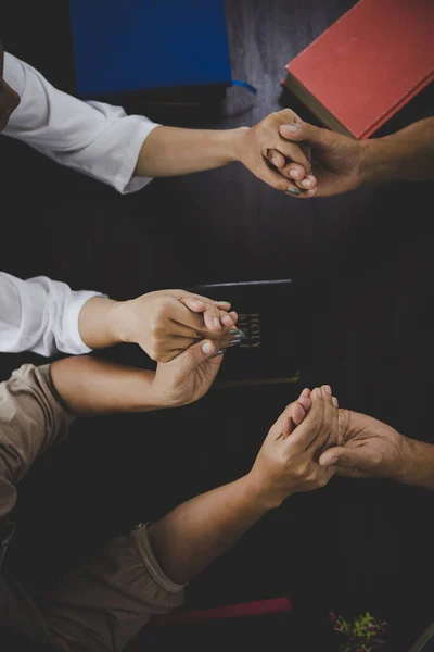 Group of people praying worship believe. soft focus, praying and praise together at home. devotional or prayer meeting concept.