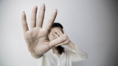 Stop hurting woman! young female person raised her hand for stop violence, sexual abuse, human trafficking, domestic violence and rape, International Day for the Elimination of Violence against Women