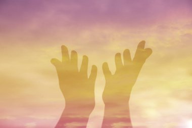 Person human hands open palm up worship or pray for god. background is sunrise. Concept for Christian, Christianity, Catholic religion, divine, heavenly, celestial or god.