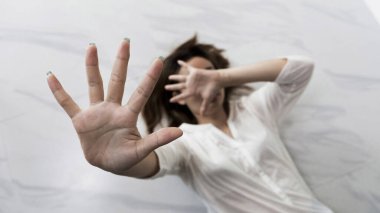 Stop hurting woman! young female person raised her hand for stop violence, sexual abuse, human trafficking, domestic violence and rape, International Day for the Elimination of Violence against Women