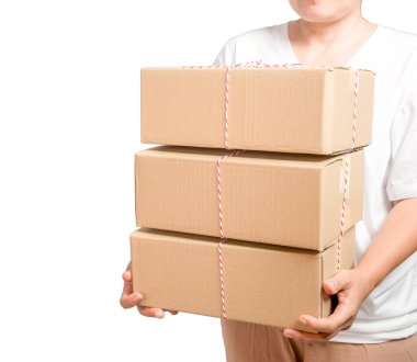 A parcel cardboard parcel box in a delivery woman person hands isolated on white background. Delivery service concept. Asian Young girl holding a package is a delivery business entrepreneur.