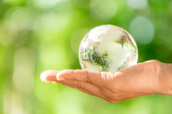 Human Hand Holding Globe Planet Glass Green Forest Bokeh Nature — Stockfoto