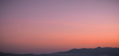 Beautiful bright cloud sky with light for heaven religion background. Sunrise and twilight or sunset cloudscape is orange and blue colours in summer nature.