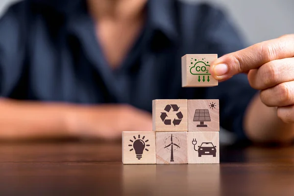 Companies are targeting net zero greenhouse gas emissions. Carbon credit concept.Tradable certificate to drive industry in direction of low emissions in efficiency cost. Wooden cubes with decrease CO2