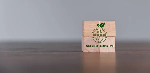 Companies are targeting net zero greenhouse gas emissions. Carbon credit concept.Tradable certificate to drive industry in direction of low emissions in efficiency cost. Wooden cubes with decrease CO2