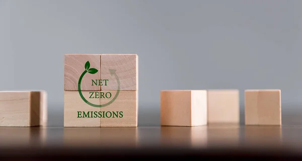 Companies are targeting net zero greenhouse gas emissions. Carbon credit concept.Tradable certificate to drive industry in direction of low emissions in efficiency cost. Wooden cubes with decrease CO2