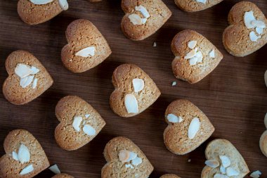 Bir grup Kalp Kurabiyesi 'nin yakın çekimi. Çikolata, peynir ve çilek, yulaf ezmesi, beyaz çikolata çerçeveyi doldurur. Masada ev yapımı kurabiyeler var. Çikolata parçacıklı kurabiye..