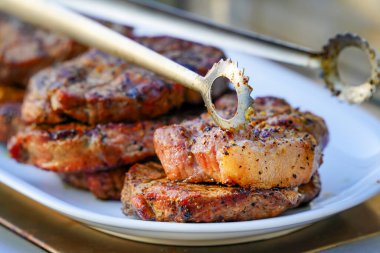 Yanmış Sulu Biftekler Barbekü Cızgarası Tuz ve Kara Biberle Beyaz Tabakta Yaz Pikniği İçin Izgara Mangalda.