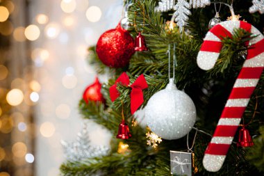 Kırmızı süslemeli ve altın ışıklı arka planda şeker kamışlı Noel Ağacı, Tatil Kavramları