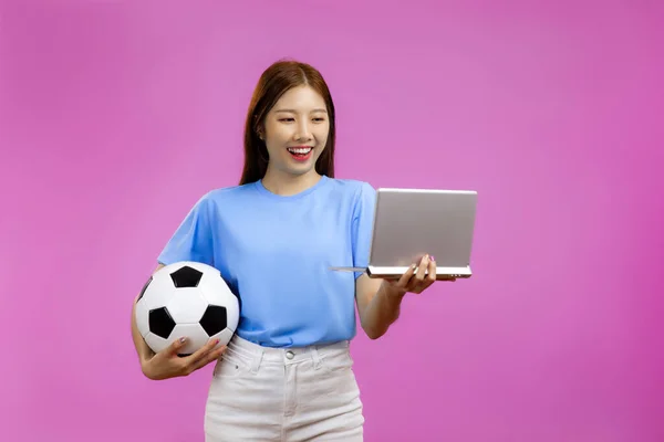 Asian Young Woman Isolated Pink Background Holding Soccer Ball Laptop — Stock Fotó