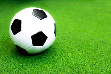 soccer ball on the green artificial grass field for sport background. football concept.
