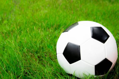 Football ball on the green field close up. sport concept background.