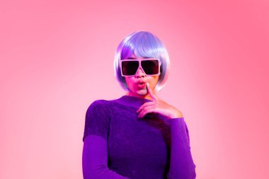 Cyber punk girl concept, asian woman in purple sweatshirt silver and blue short hair style wearing sunglasses posing like robot.