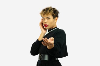 pretty gay man posing in a black dress. Transgender isolated white color wall. LGBTQ+ concept.