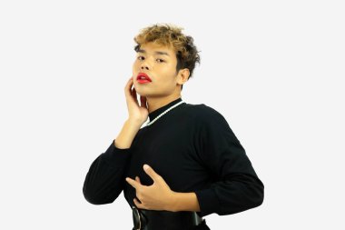 pretty gay man posing in a black dress. Transgender isolated white color background. LGBTQ+ concept.