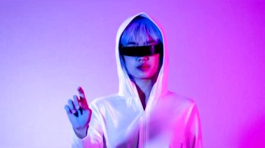 Metaverse concept, young asian woman wearing black 3 glasses touching on the purple screen background. 4K video asian girl futuristic style gamer.