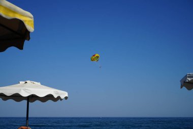 Akdeniz 'de parasailing. Parasailing, paraşüt kanadını andıran ve paraşüt kanadına benzeyen bir paraşüt kanadına bağlı bir aracın arkasına çekilen bir eğlence amaçlı uçurtma aktivitesidir. Rodos, Yunanistan  